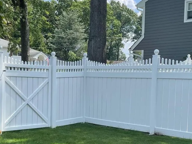 White vinyl privacy fence installed in a residential backyard in New Jersey