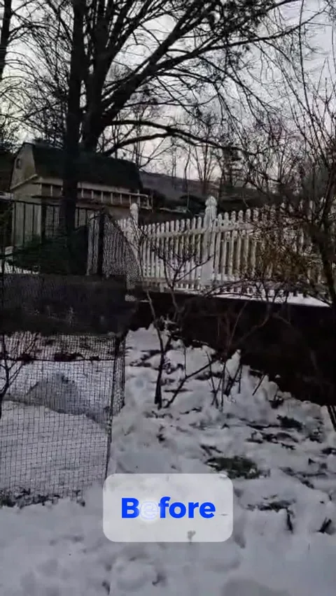 White vinyl picket fence in a snowy backyard